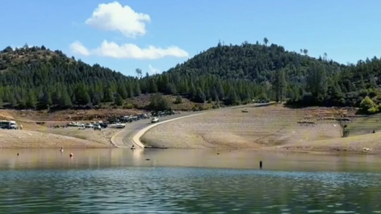 Jones Valley public boat ramp seen from the water, with the ramp road and parking lot above the low-water shoreline